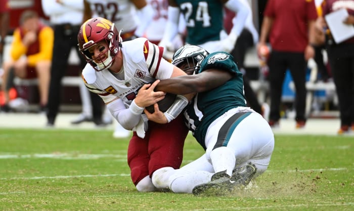Philadelphia Eagles defensive tackle Javon Hargrave (97) tackles Washington Commanders quarterback Carson Wentz
